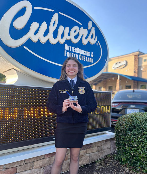 FFA member smiles in front of Culver’s marquee.